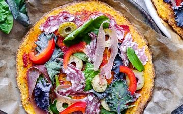 A healthy paleo pumpkin pizza crust recipe using mashed pumpkin, almond flour and psyllium husk. It's grain free and dairy free, and can be made vegan using a flax egg!