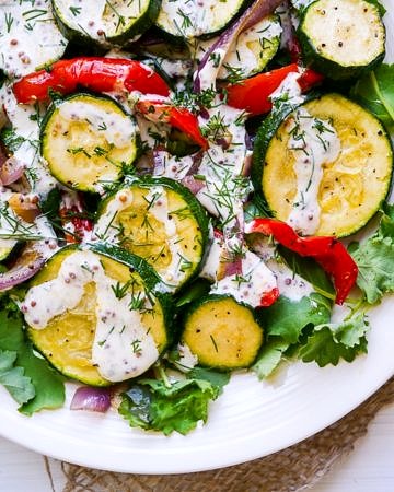 Roasted Zucchini Salad with Yoghurt Dill Dressing - This healthy roasted zucchini salad recipe is quick and easy to prepare. Gluten free & grain free, topped with a creamy yoghurt-dill dressing! Recipe via wordpress-6440-15949-223058.cloudwaysapps.com