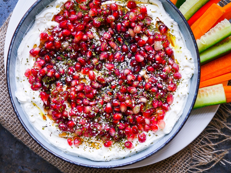 Balsamic Pomegranate Labneh Dip. Strained yoghurt dip plated up with pomegranate arils, balsamic vinegar and dried herbs on top. A healthy appetiser that is just perfect for entertaining and parties.