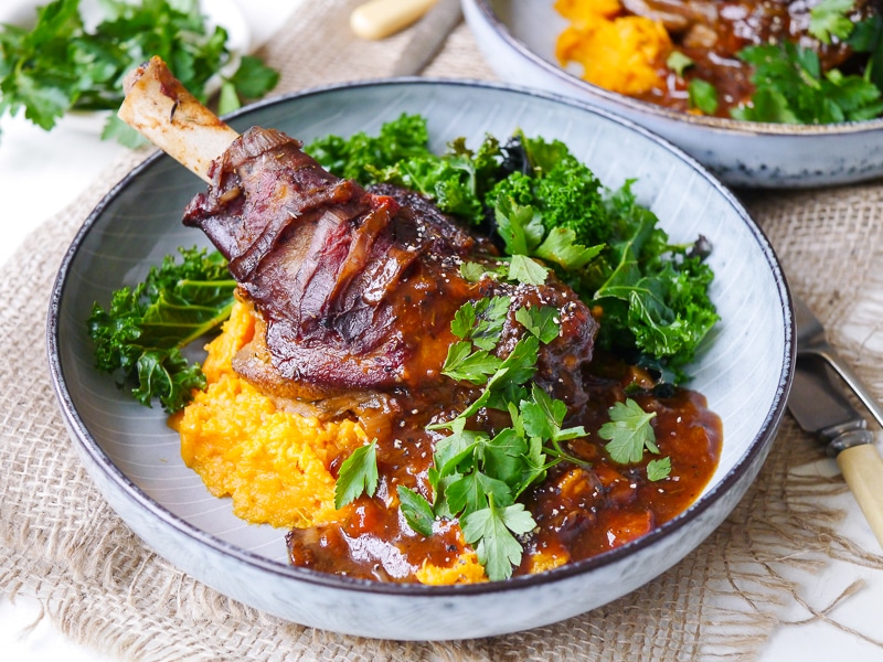 Balsamic slow cooker lamb shanks made with dried thyme and a rich tomato sauce. Tastes luxurious but healthy! Gluten free, dairy free and really easy to make!