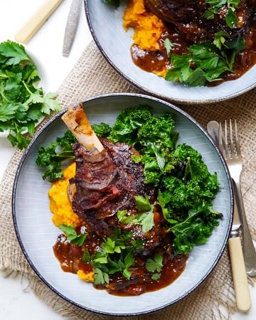 Balsamic slow cooker lamb shanks made with dried thyme and a rich flavoursome tomato sauce. Gluten free, dairy free and really easy to make! Recipe at wordpress-6440-15949-223058.cloudwaysapps.com