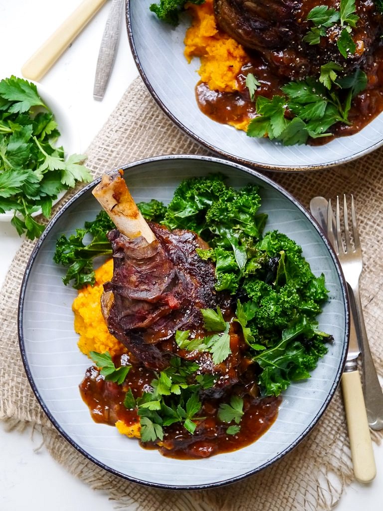 Balsamic slow cooker lamb shanks made with dried thyme and a rich tomato sauce. Tastes luxurious but healthy! Gluten free, dairy free and really easy to make!