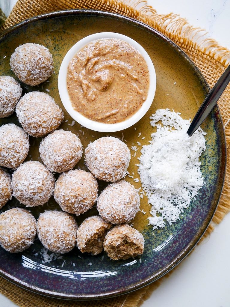 Healthy protein balls with peanut butter and coconut on a blue ceramic plate