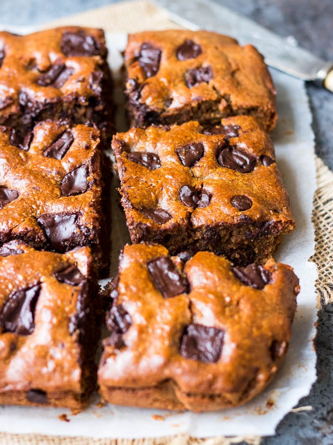 These easy blender chocolate almond butter bars are studded with dark chocolate chunks. Gluten free, grain free (paleo) and dairy free, a healthier dessert or indulgent snack!