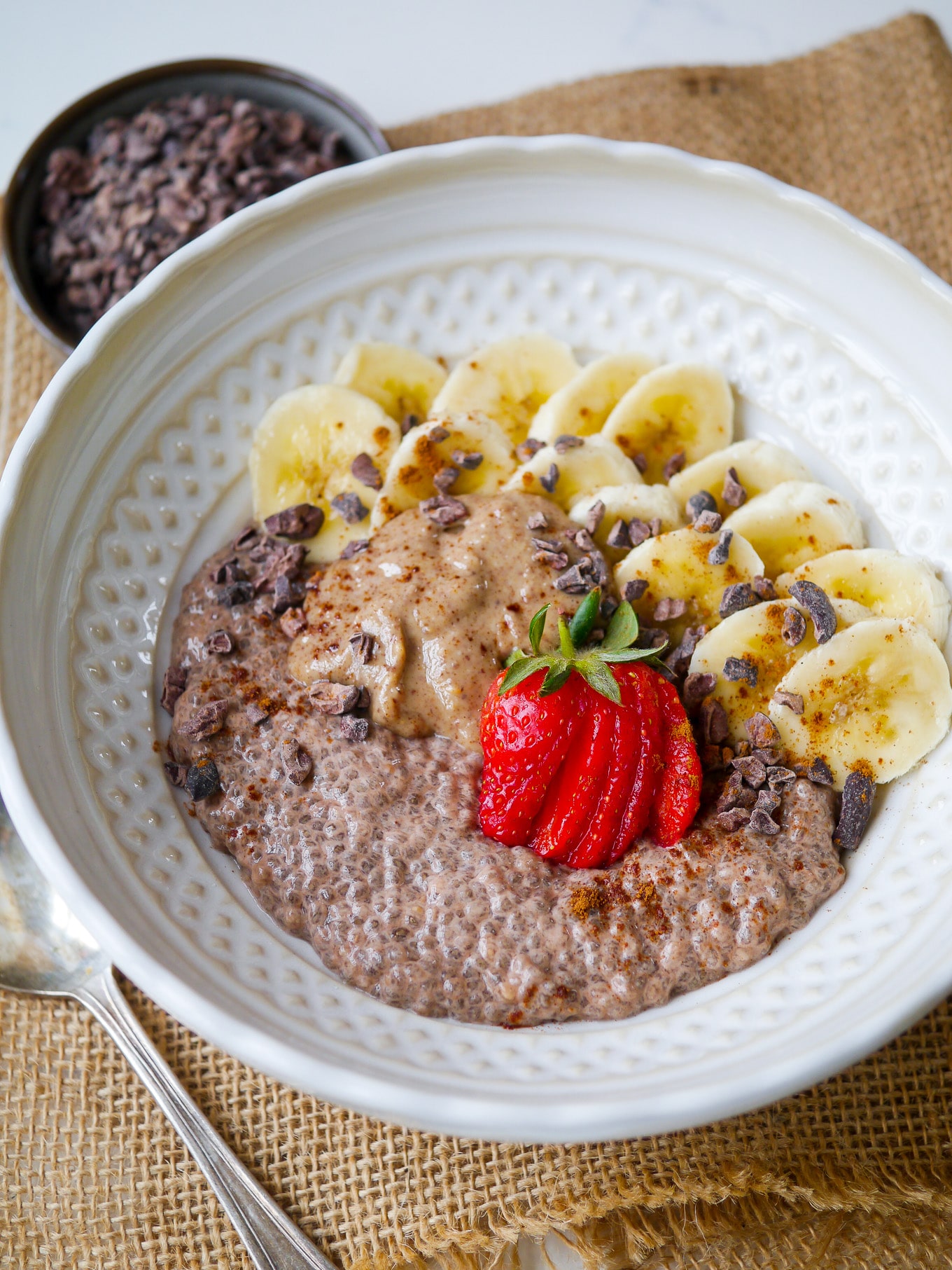 Easy Chunky Monkey Chia Pudding - cacao chia pudding made with creamy nut milk and served with sliced banana, peanut butter and cacao nibs. Yum! #glutenfree #dairyfree #chiapudding
