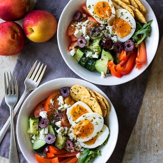 Meal prep breakfast bowls Greek style, combining boiled eggs with chopped cucumber, tomatoes, capsicum, feta and olives. Loads of fresh veggies and protein will give you the best healthy start to the day!