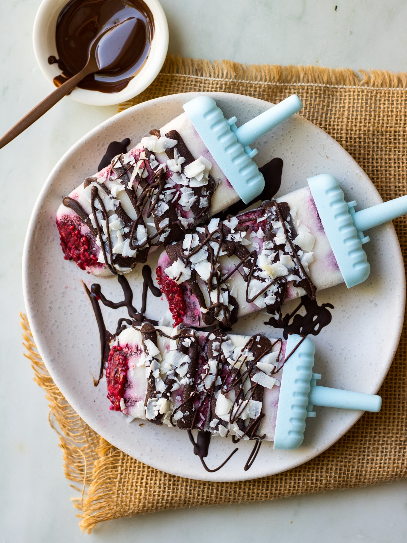 Creamy coconut #lamington popsicles are a healthy vegan frozen dessert, made with coconut yoghurt, raspberry chia jam and dark chocolate. Easy to make! #dairyfree #popsicles #vegan