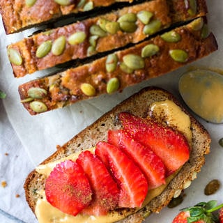 Apple Zucchini Snack Cake shot from top down, close up, one slice flat topped with nut butter and sliced strawberries