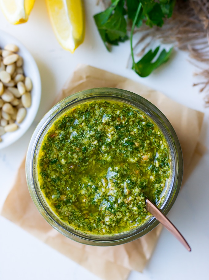 Lemon basil pesto in a small glass jar with spoon