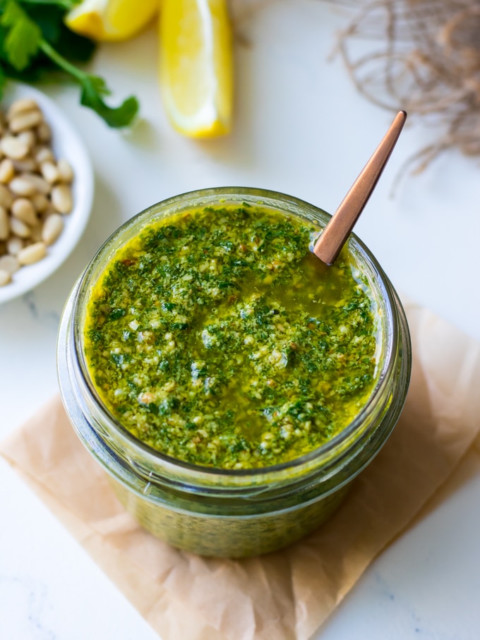 Lemon basil pesto in a small glass jar with spoon
