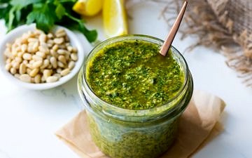 Lemon basil pesto in a small glass jar with spoon