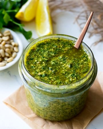 Lemon basil pesto in a small glass jar with spoon