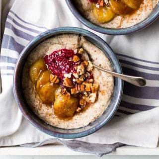 creamy quinoa porridge in blue ceramic bowls with berries and banana