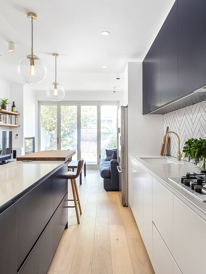 Terrace kitchen renovation (white and navy cabinets, subway tiles, kitchen island)