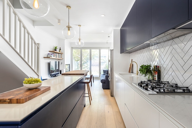 Terrace kitchen renovation (white and navy cabinets, subway tiles, kitchen island)