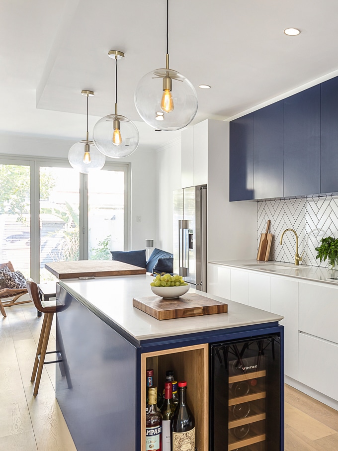 Terrace kitchen renovation (white and navy cabinets, subway tiles, kitchen island)