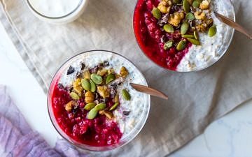 raspberry kefir overnight oats top view, in glasses with crunchy toppings