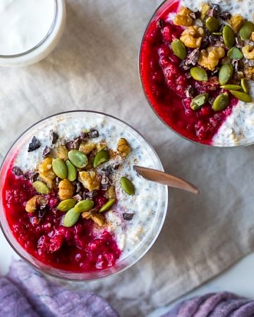 raspberry kefir overnight oats top view, in glasses with crunchy toppings