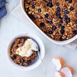coconut blueberry baked oats with Greek yoghurt dish and serving bowl
