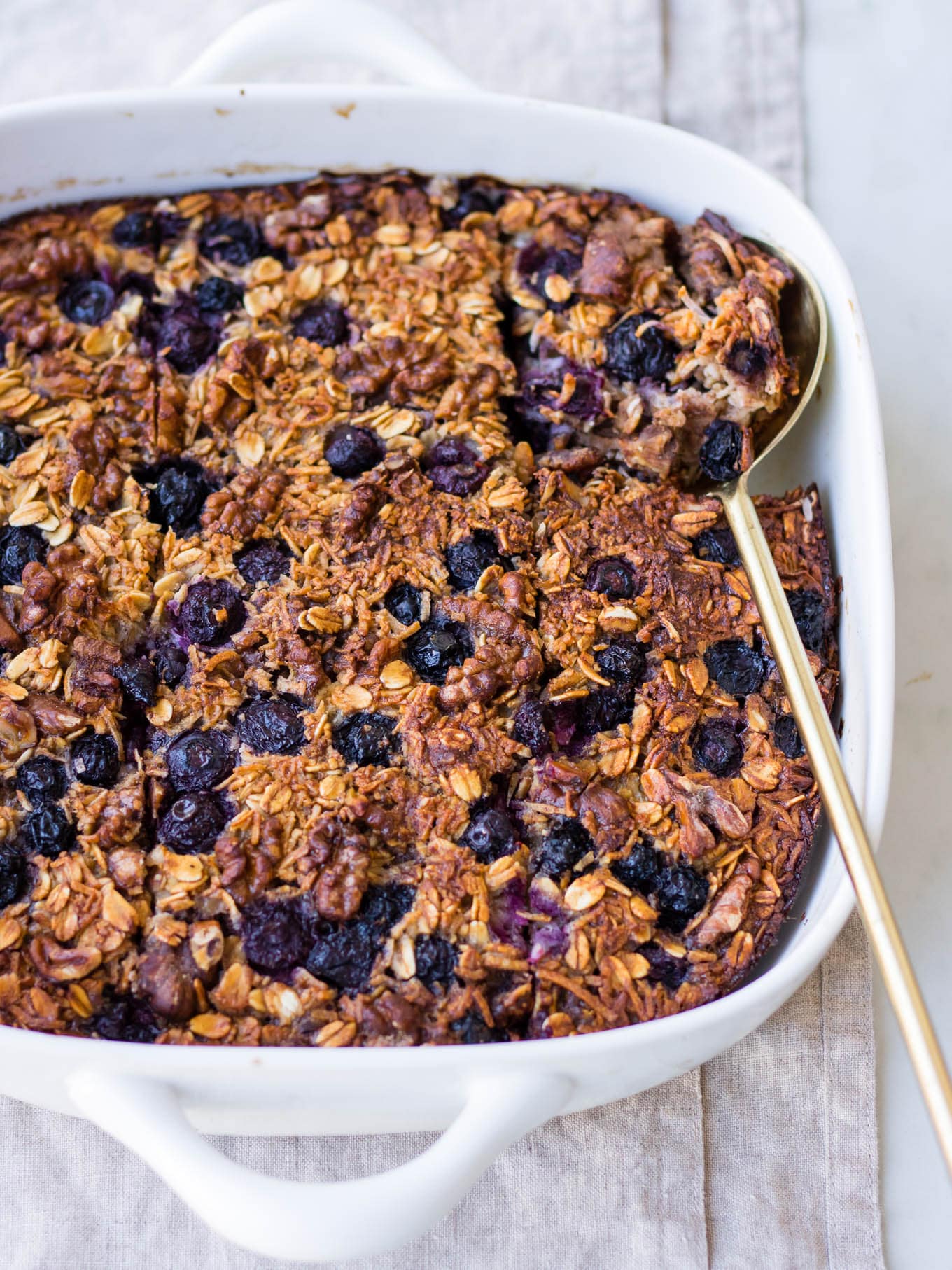 coconut blueberry baked oats in white square baking dish