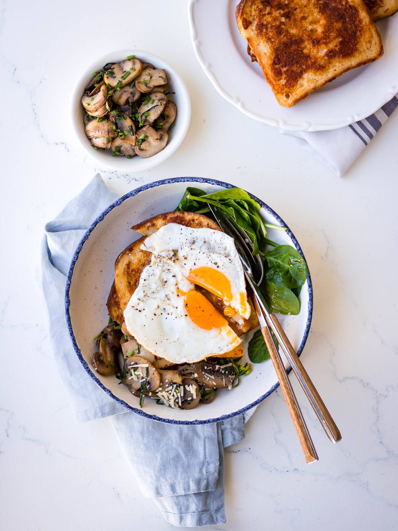 Savoury french toast with mushrooms, parmesan and a fried egg on top
