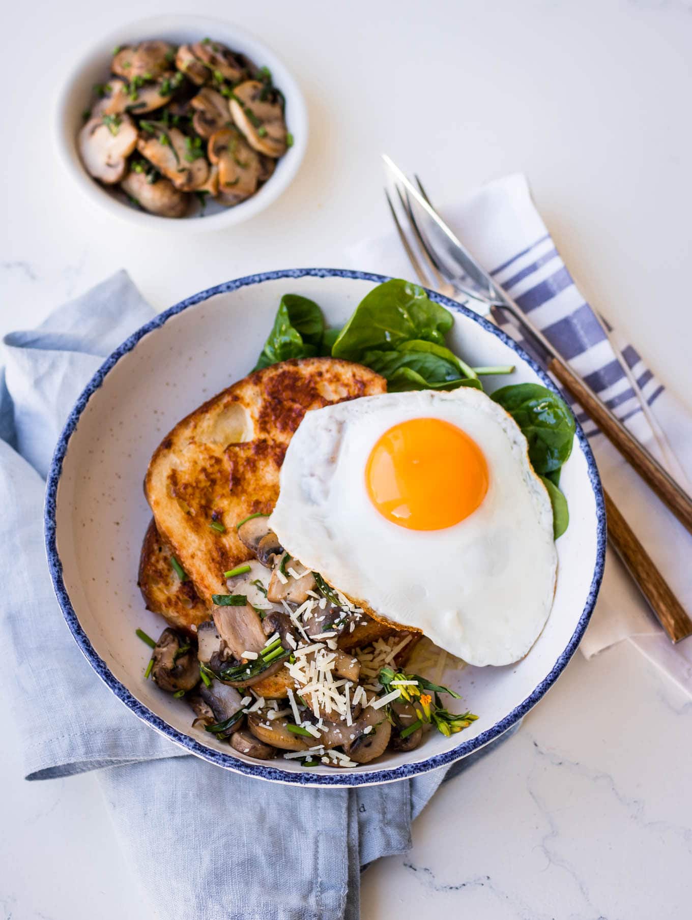 Savoury french toast with mushrooms, parmesan and a fried egg on top