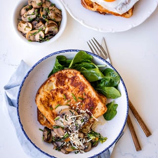 Savoury french toast with mushrooms and parmesan, white bowl, blue napkin