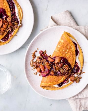 Sweet cinnamon omelettes with berry compote and granola topping
