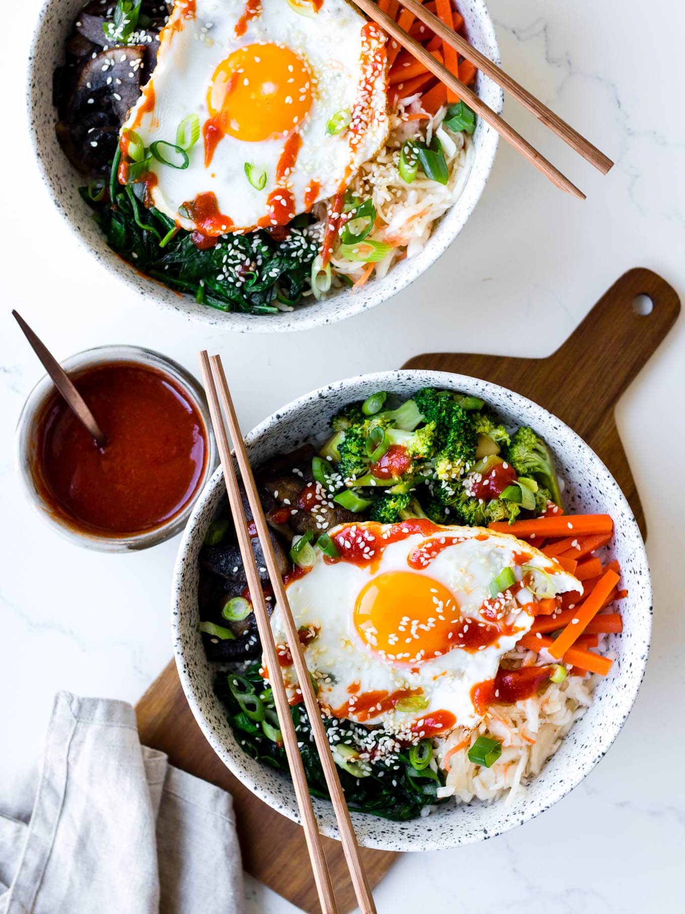 vegetarian bibimbap bowls in white ceramic bowl with pickles