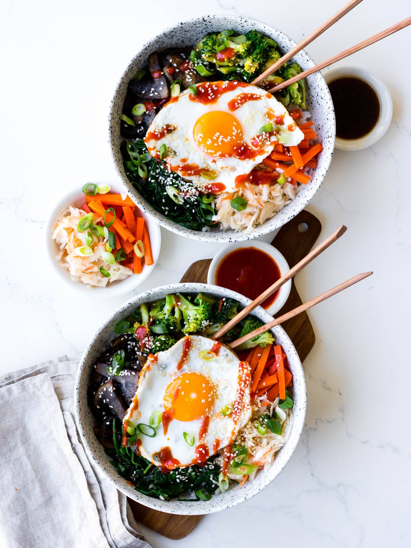 vegetarian bibimbap bowls in white ceramic bowls with pickles