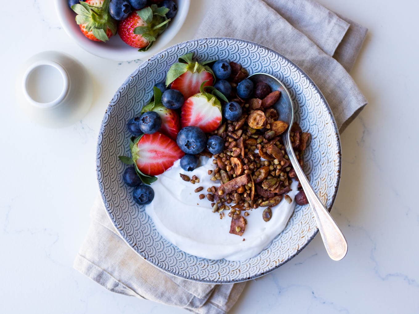 Gluten free cacao hazelnut granola with yoghurt and berries