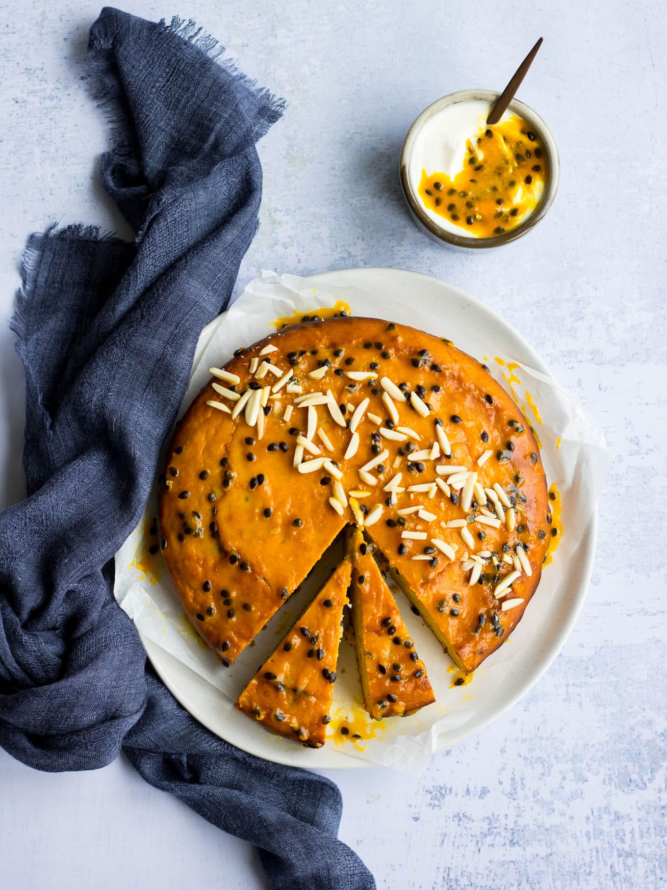 passionfruit yoghurt cake with passionfruit glaze and almonds