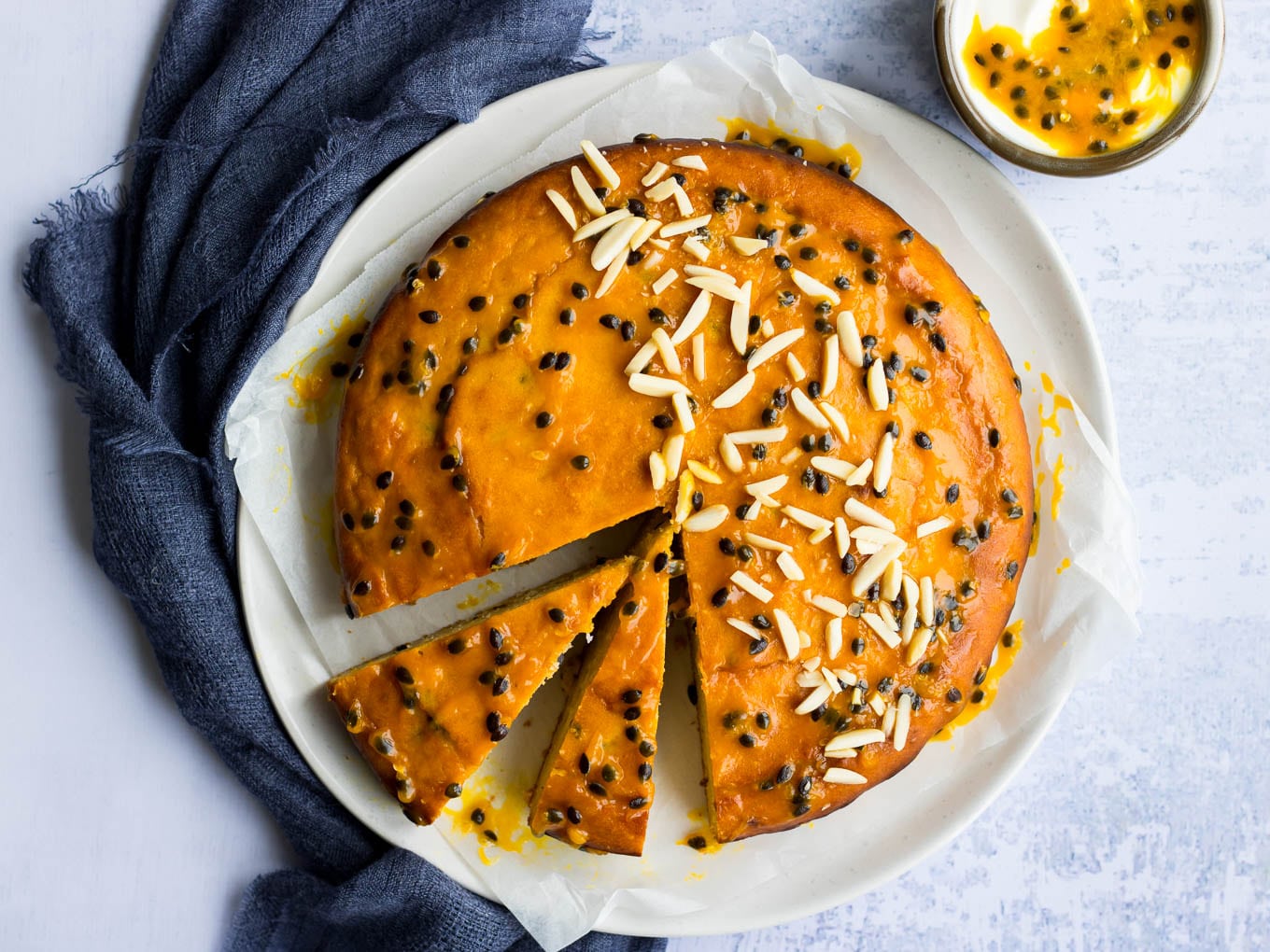 passionfruit yoghurt cake with passionfruit glaze and almonds