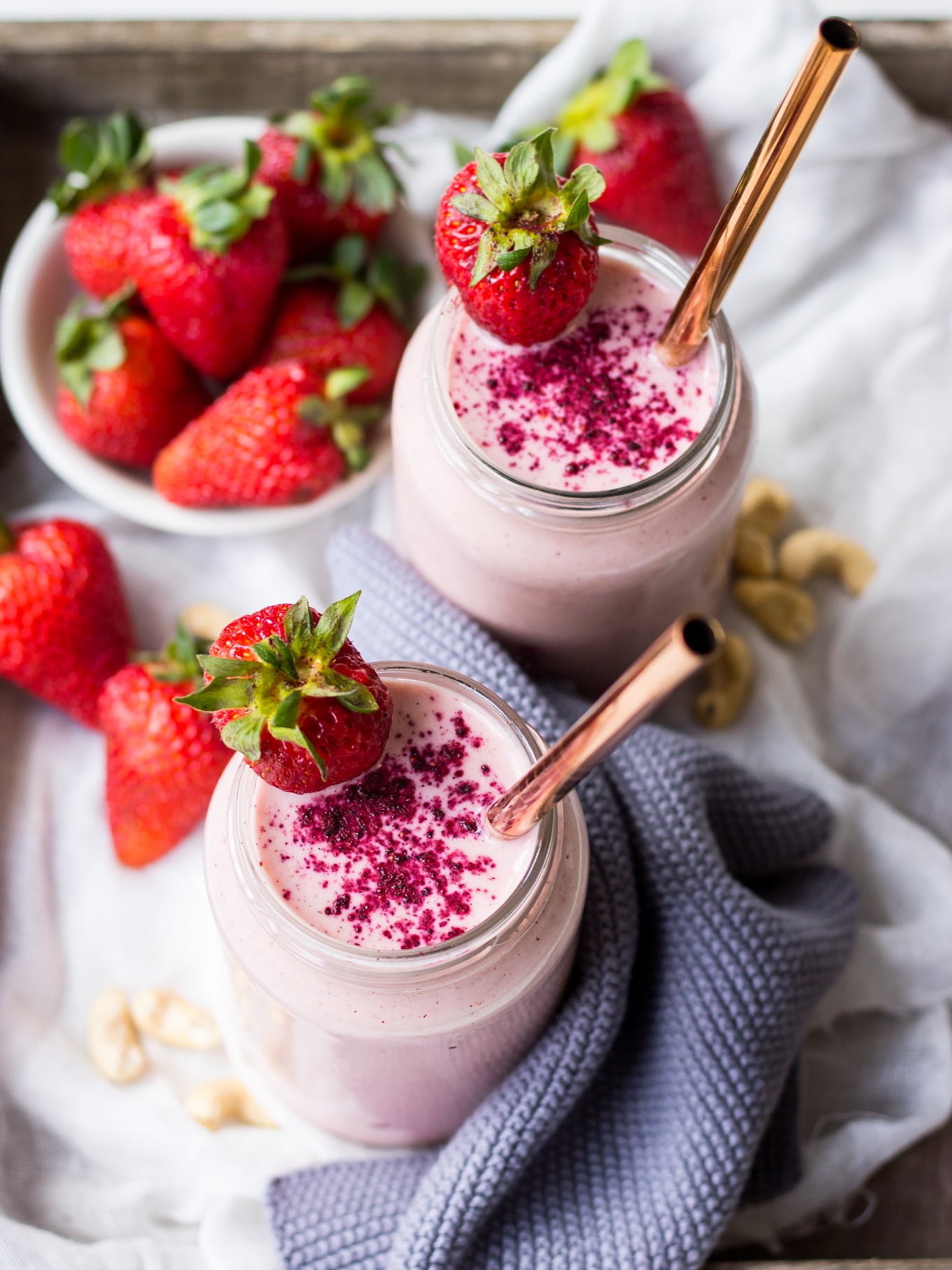 strawberry shortcake smoothie recipe, strawberry smoothies in jars on wooden tray