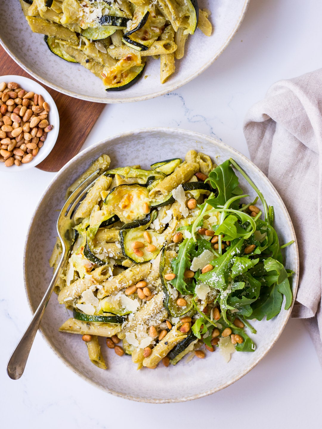 Pesto Pulse Pasta with Roasted Zucchini, Pine Nuts and Parmesan in grey ceramic bowl