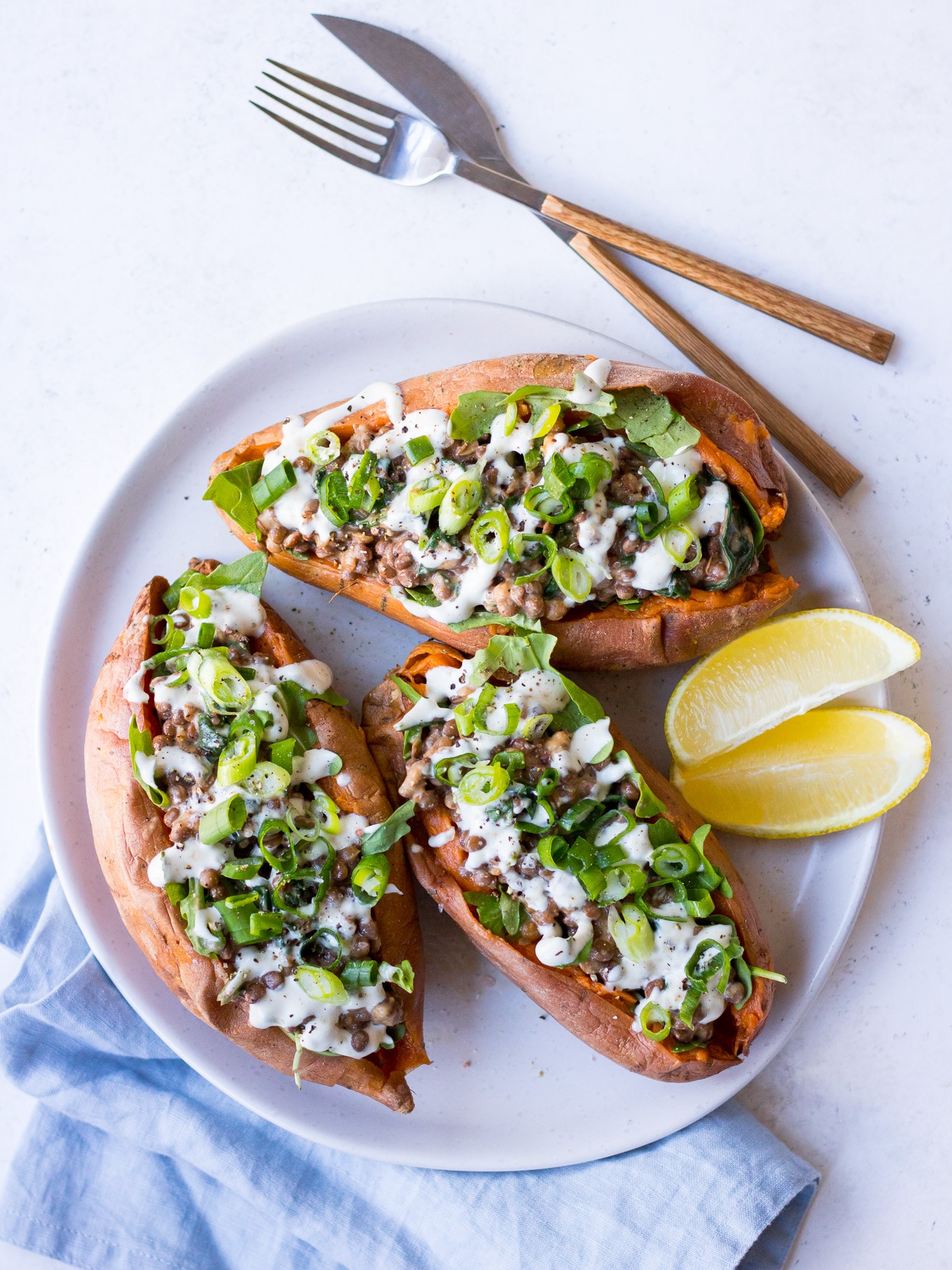 Vegan Stuffed Sweet Potatoes with creamy lentils, greens, tahini and spring onion