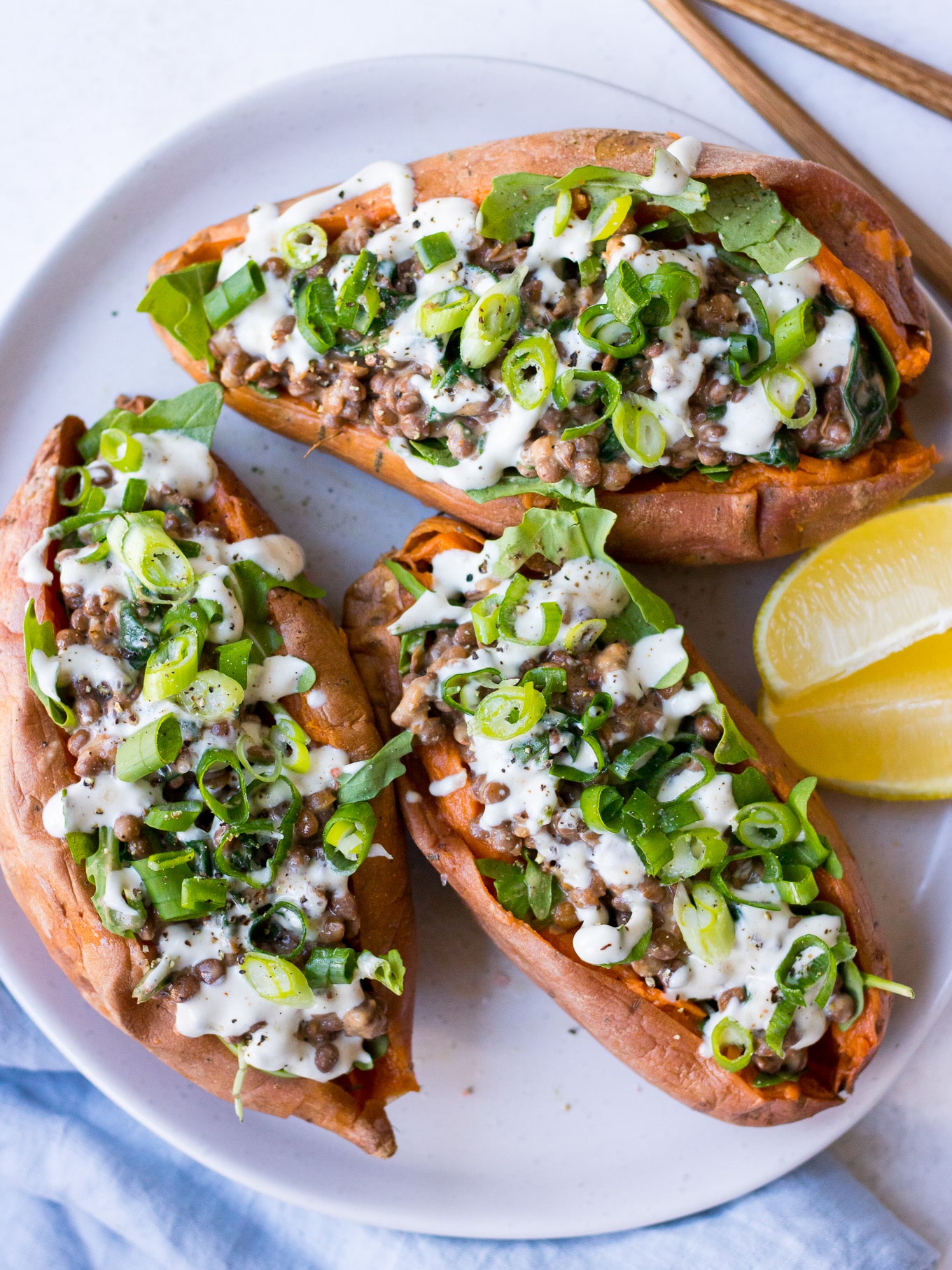 Vegan Stuffed Sweet Potatoes with creamy lentils, greens, tahini and spring onion