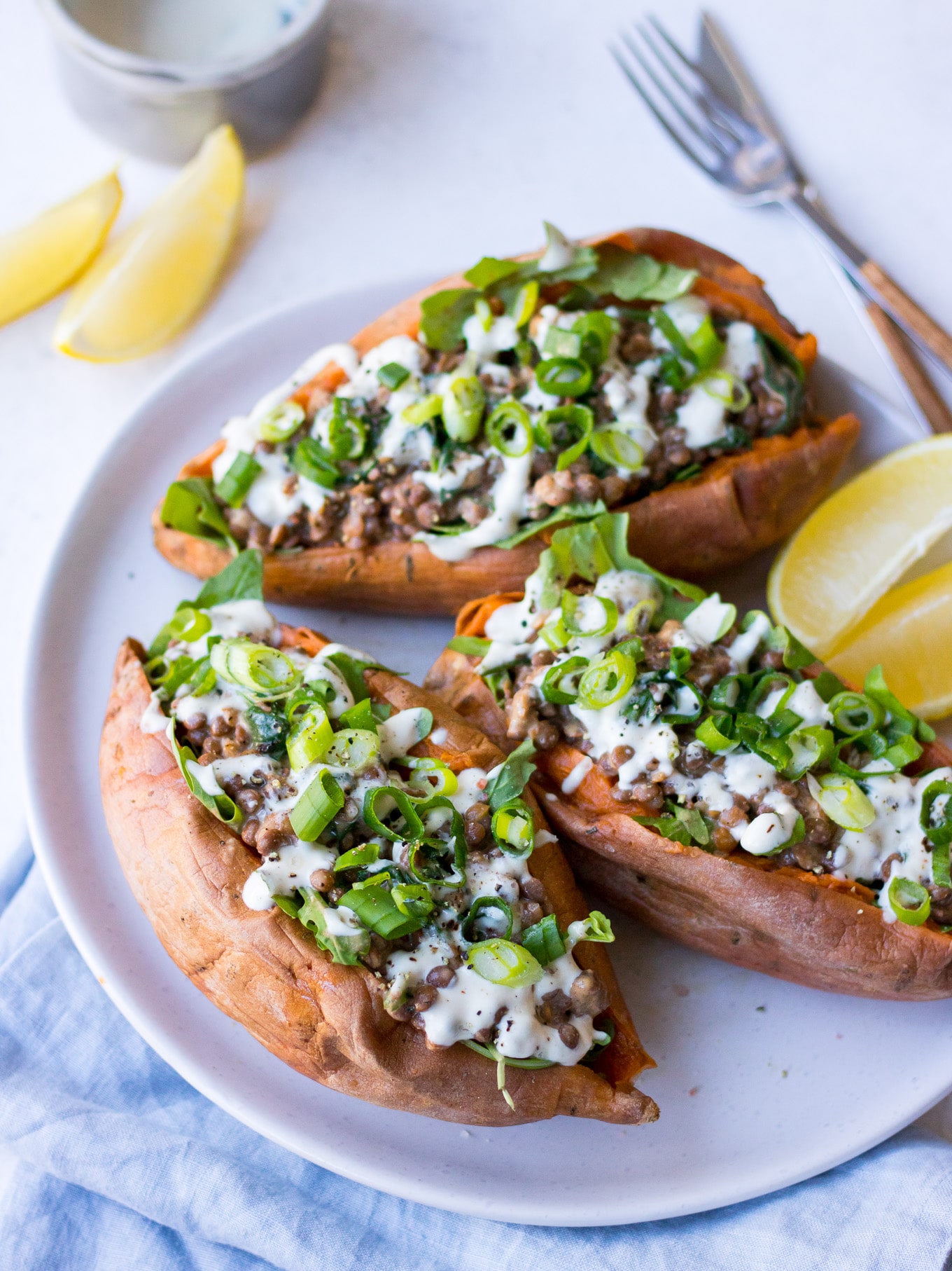 Vegan Stuffed Sweet Potatoes with creamy lentils, greens, tahini and spring onion