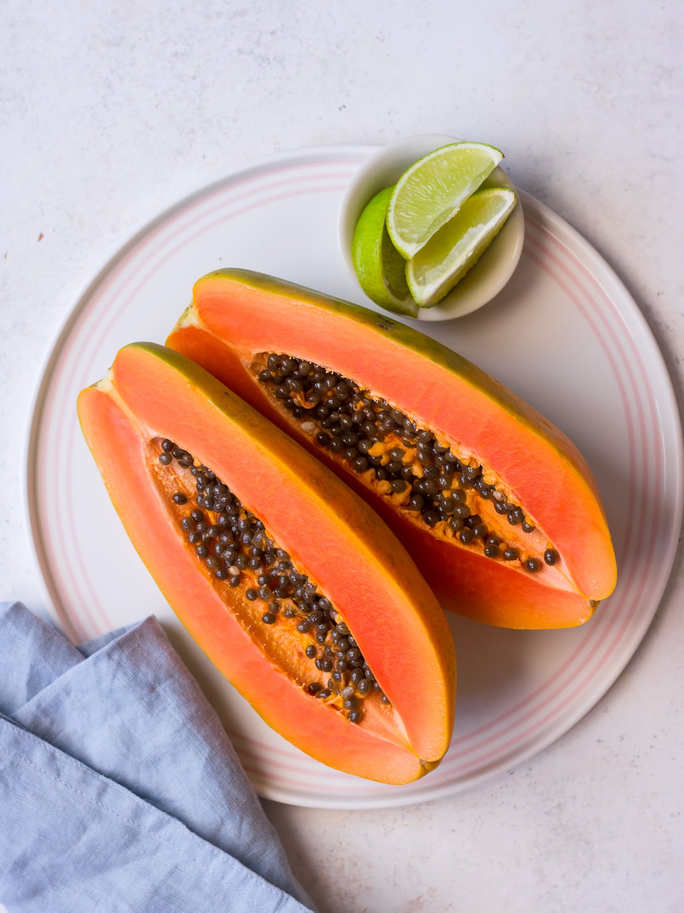 Fresh sliced red papaya with lime