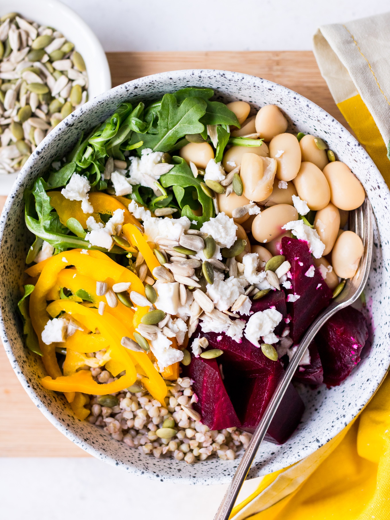 Close up of buddha bowl with roasted beetroot, feta, butter beans and seeds