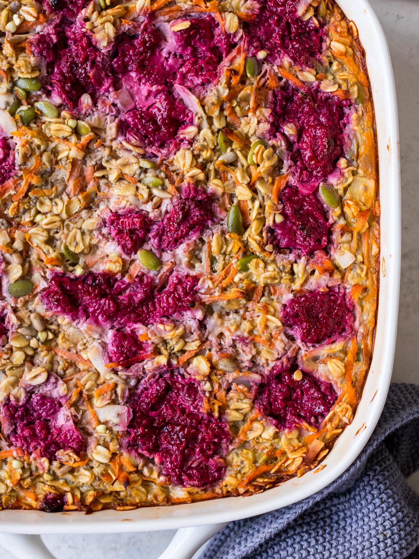 Close up of carrot baked oats topped with raspberries
