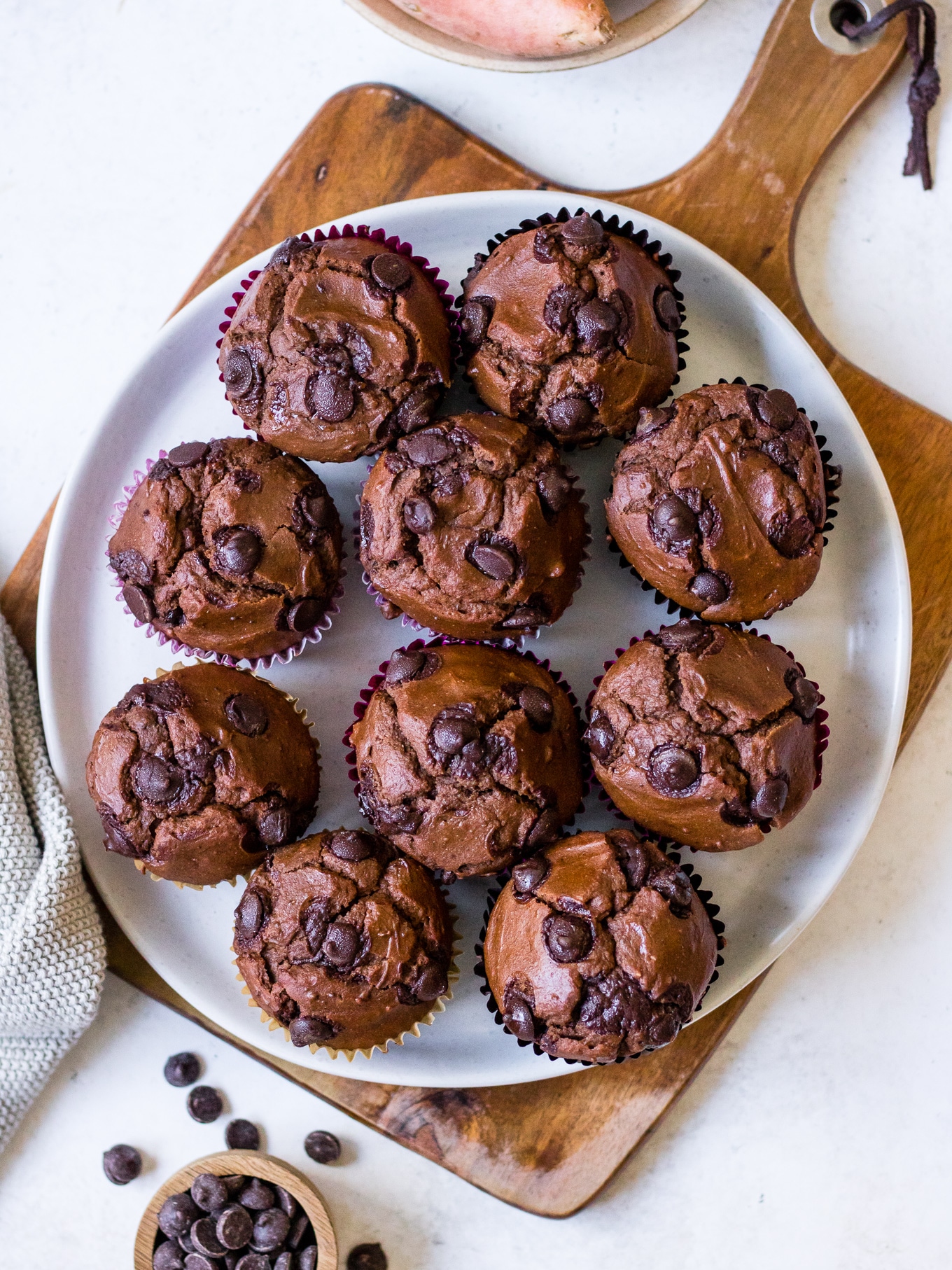 Plate of chocolate chip chocolate sweet potato muffins on chopping board