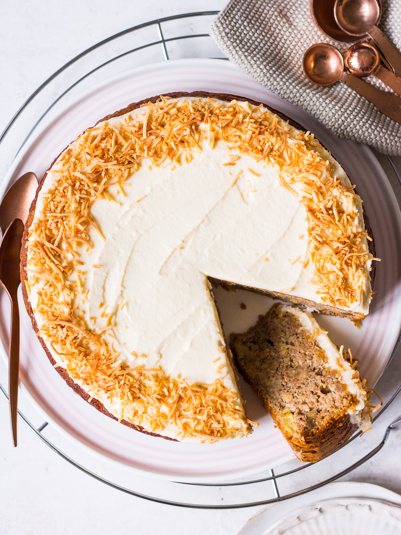Top view of Hummingbird Cake Recipe by Nourish Every Day frosted with shredded coconut