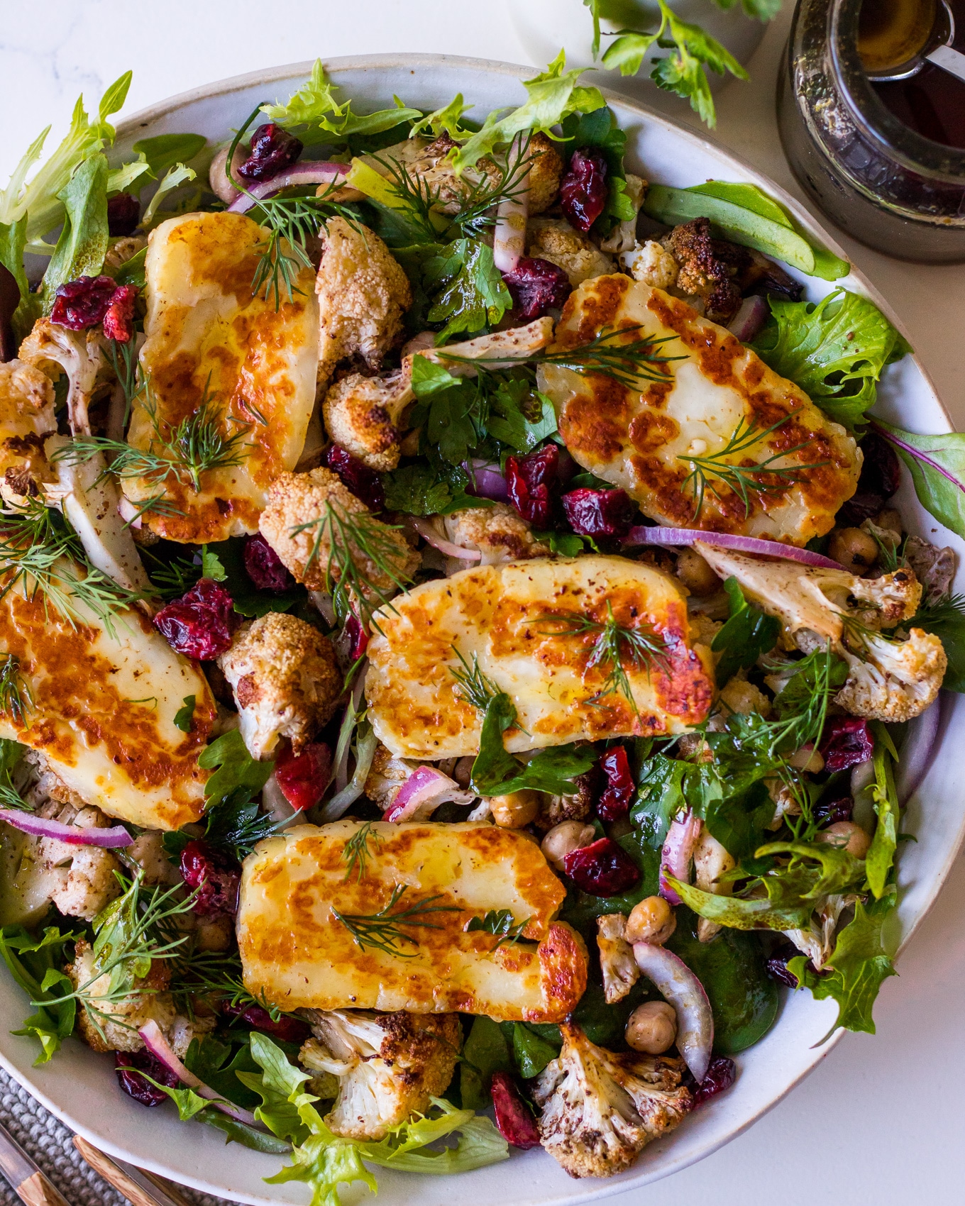Close up top view of roasted cauliflower salad with halloumi cheese