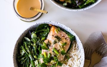 Tahini Miso Salmon in speckled white bowls with miso sauce jar