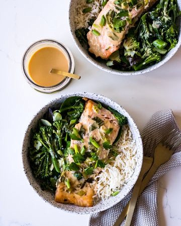Tahini Miso Salmon in speckled white bowls with miso sauce jar
