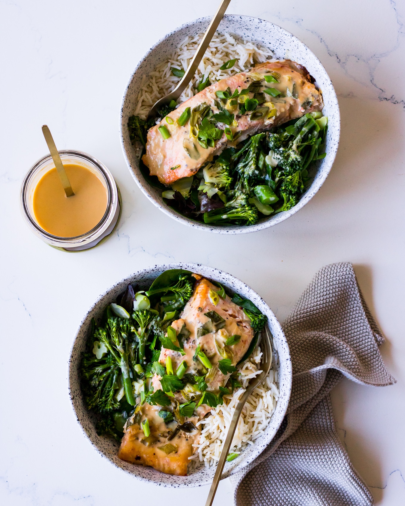 Two bowls of miso salmon, white rice and greens