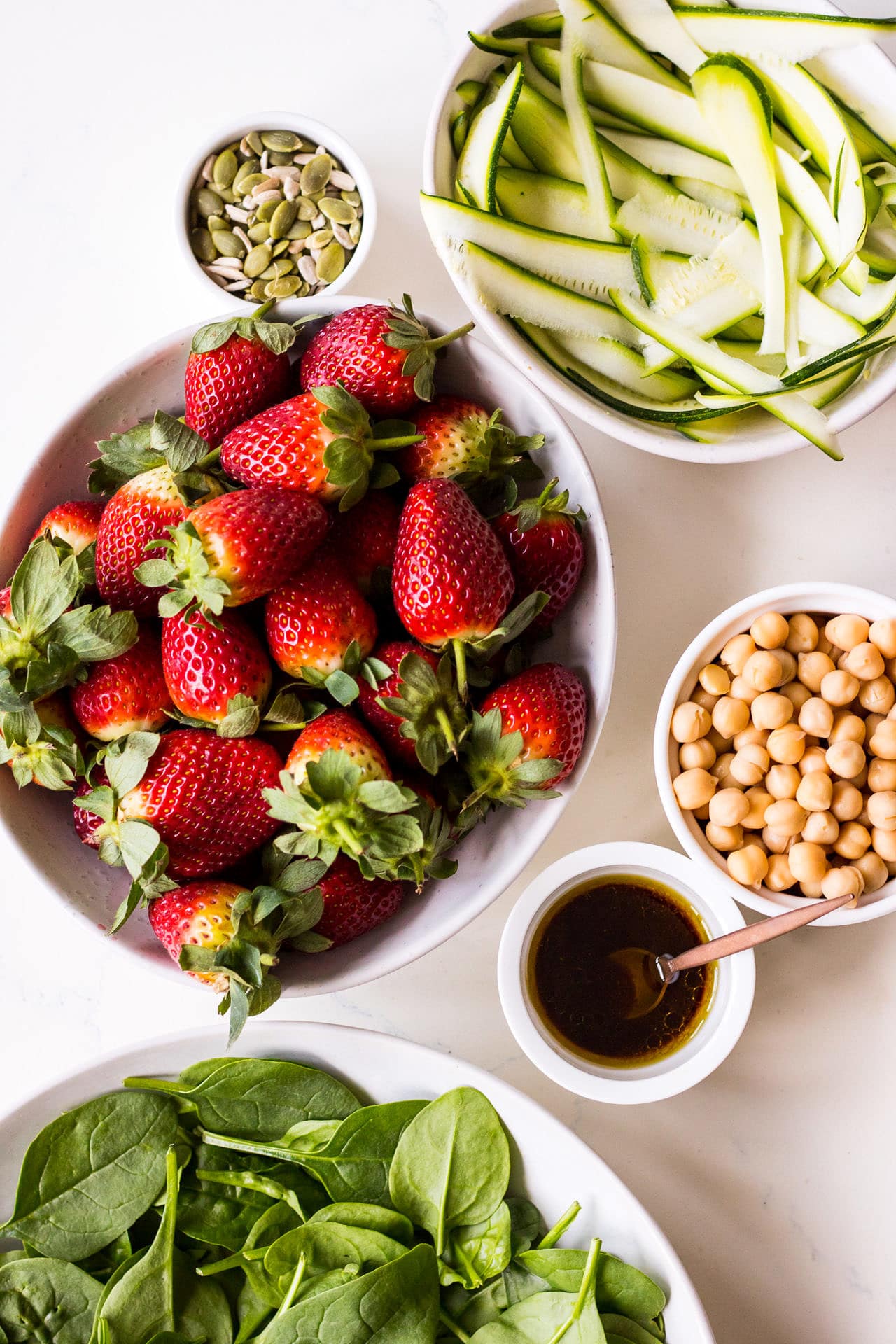 Ingredients for strawberry, zucchini, chickpea and spinach salad