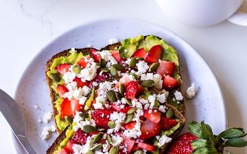 Strawberry avocado toast with a cup of tea
