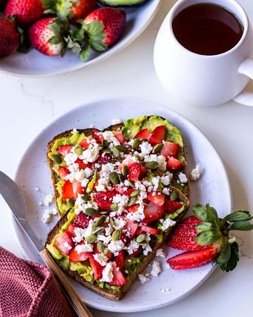 Strawberry avocado toast with a cup of tea